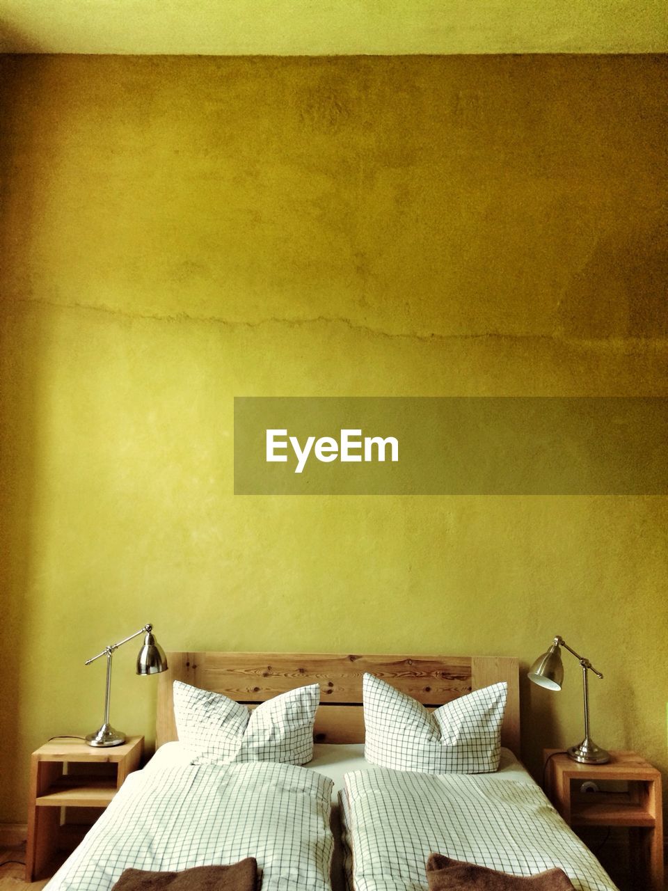 Interior of bedroom with yellow wall