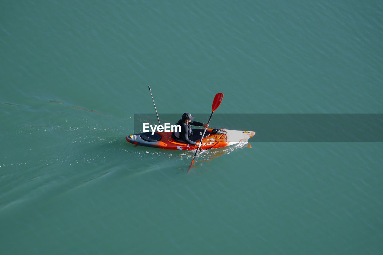 nautical vessel, water, transportation, mode of transportation, nature, vehicle, boat, high angle view, lake, men, travel, adventure, day, oar, sports, outdoors, leisure activity, kayak, beauty in nature, lifestyles, copy space, adult, one person, vacation, activity, trip