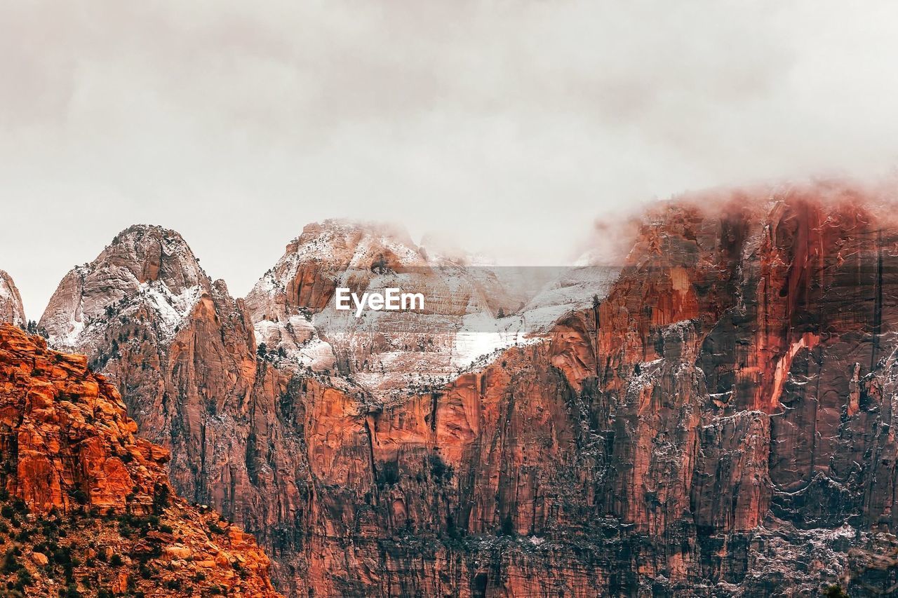 Majestic mountains against cloudy sky