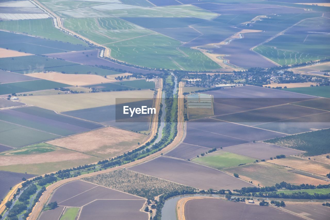 HIGH ANGLE VIEW OF AGRICULTURAL FIELD SEEN THROUGH WINDSHIELD