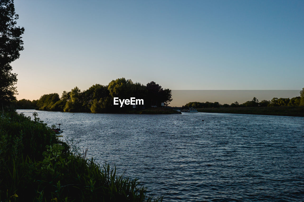 SCENIC VIEW OF LAKE AGAINST BLUE SKY