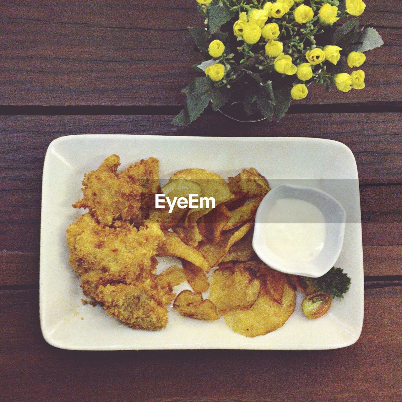 High angle view of food served on table by flower vase