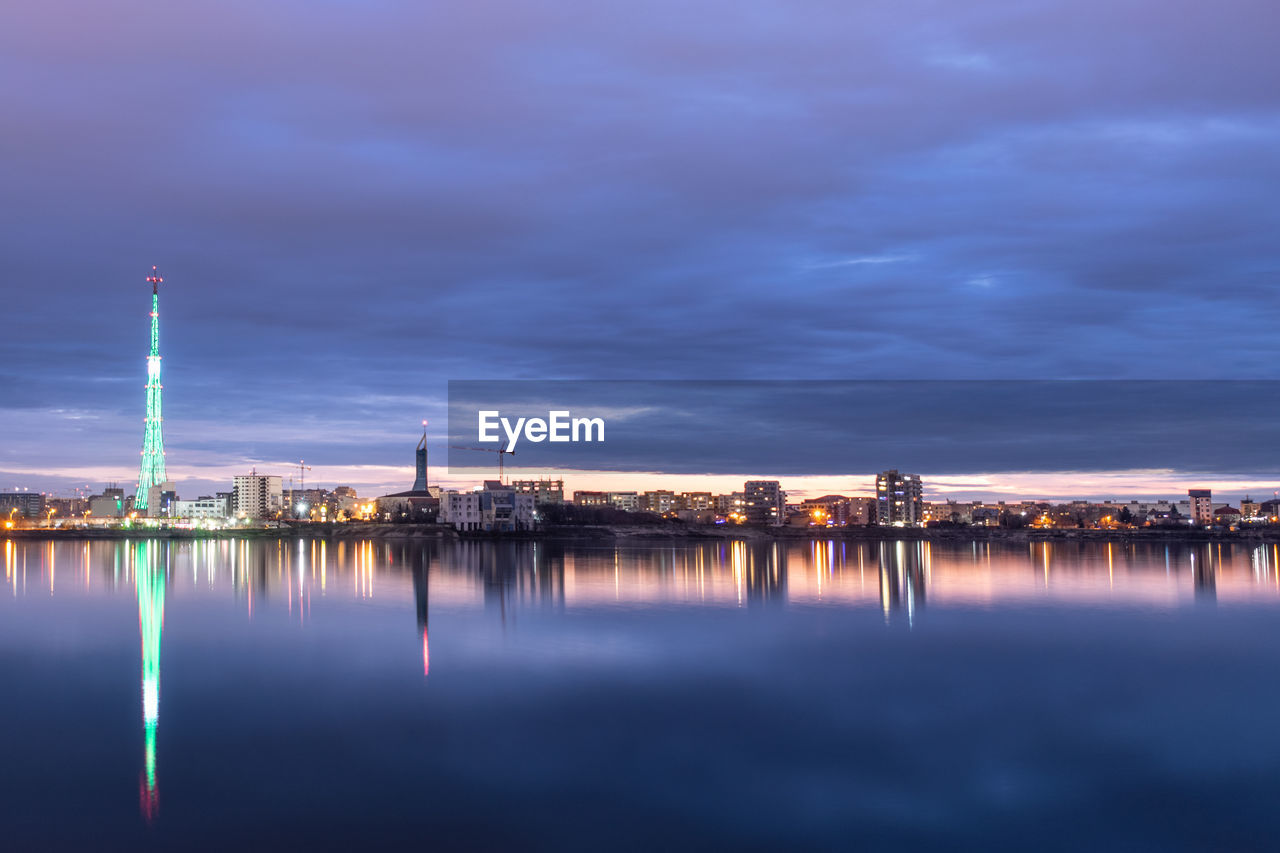 Long exposure photo of a beautiful sunset at lacul morii lake with urban buildings in the background