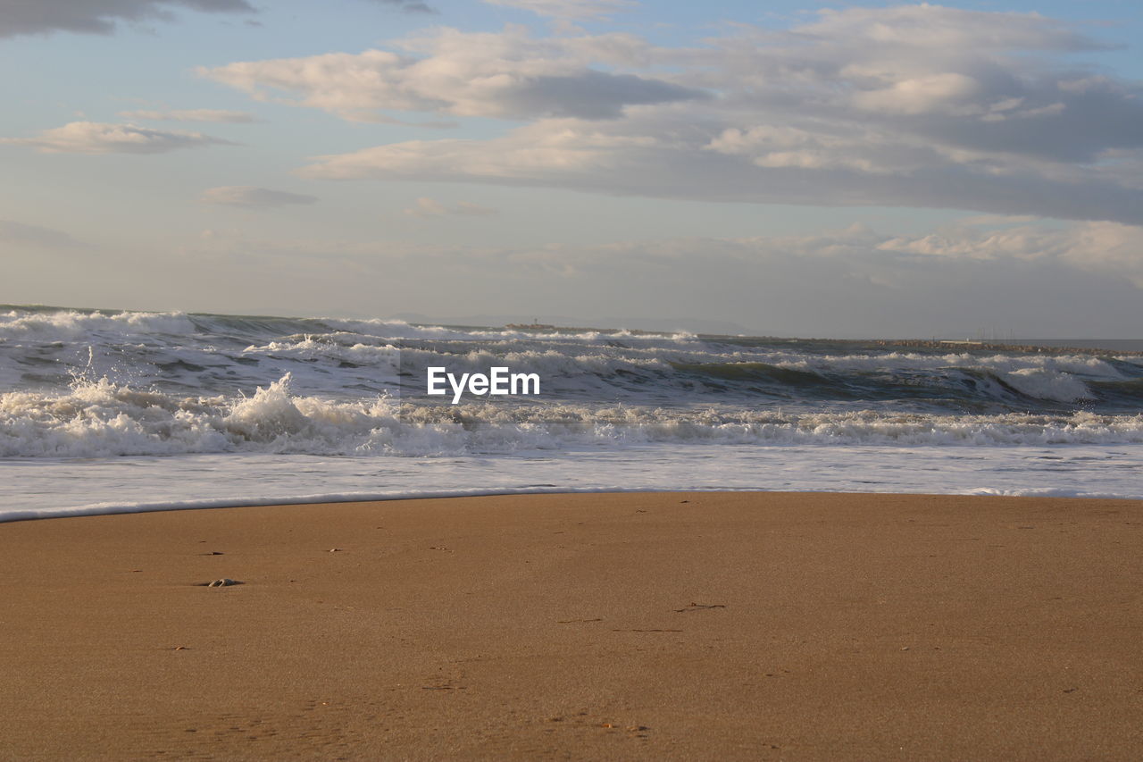 sea, beach, water, land, sky, body of water, motion, beauty in nature, wave, sand, nature, scenics - nature, cloud, wind wave, sports, shore, horizon, ocean, horizon over water, tranquility, coast, no people, water sports, tranquil scene, day, outdoors, idyllic