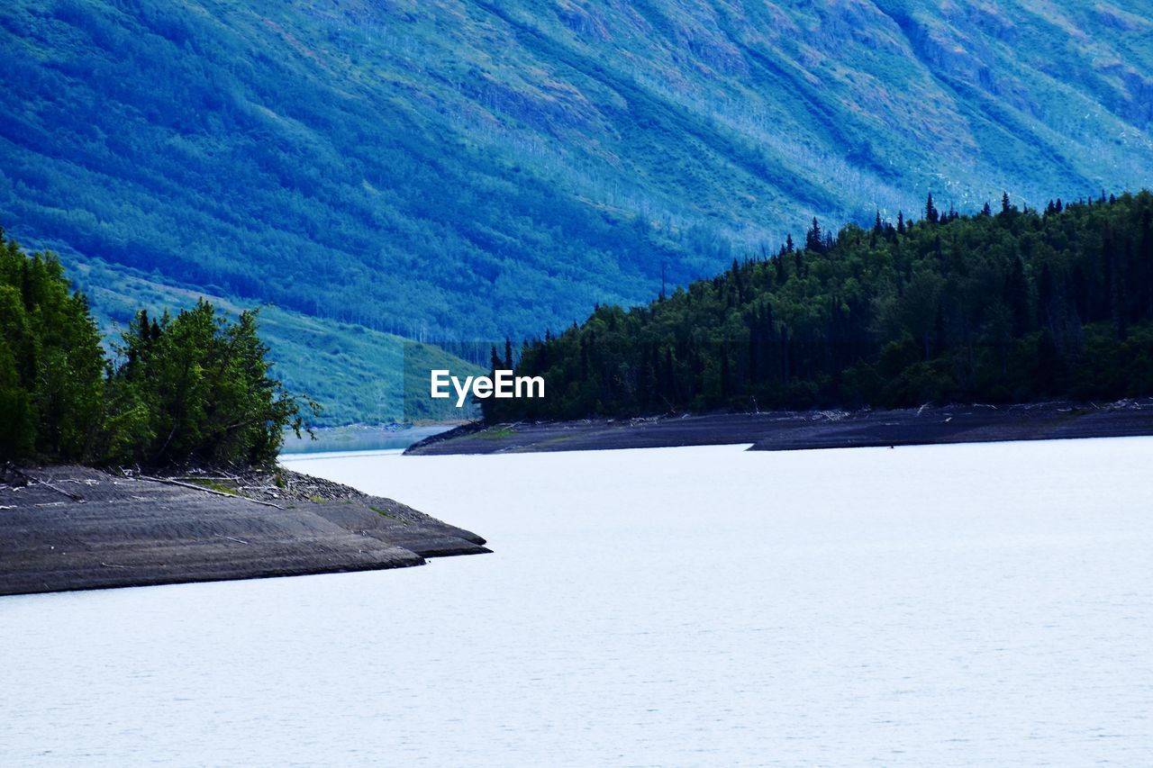 SCENIC VIEW OF LAKE AGAINST MOUNTAIN