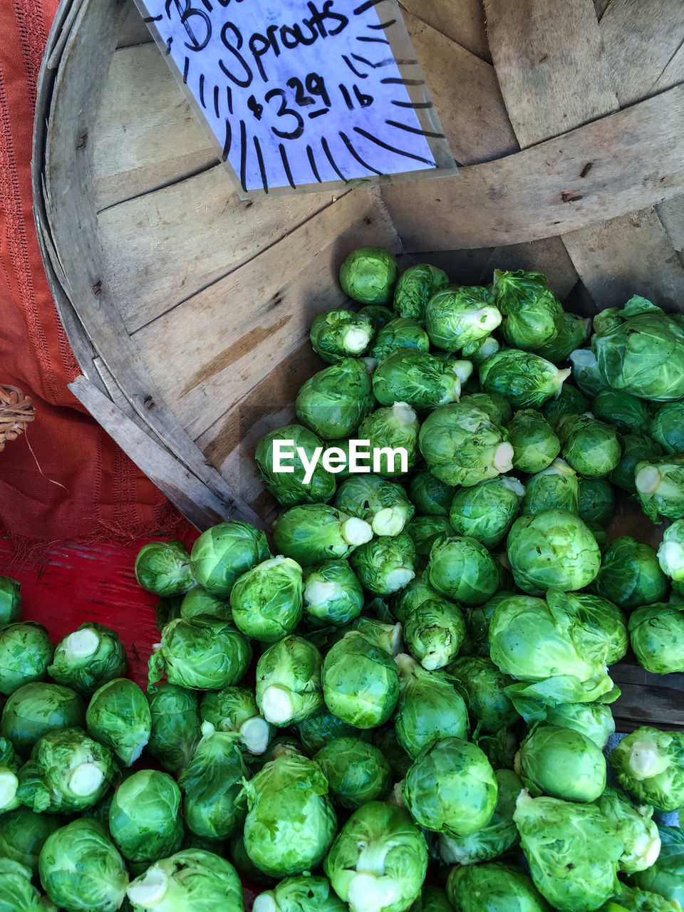 High angle view of brussels sprouts in container at market stall