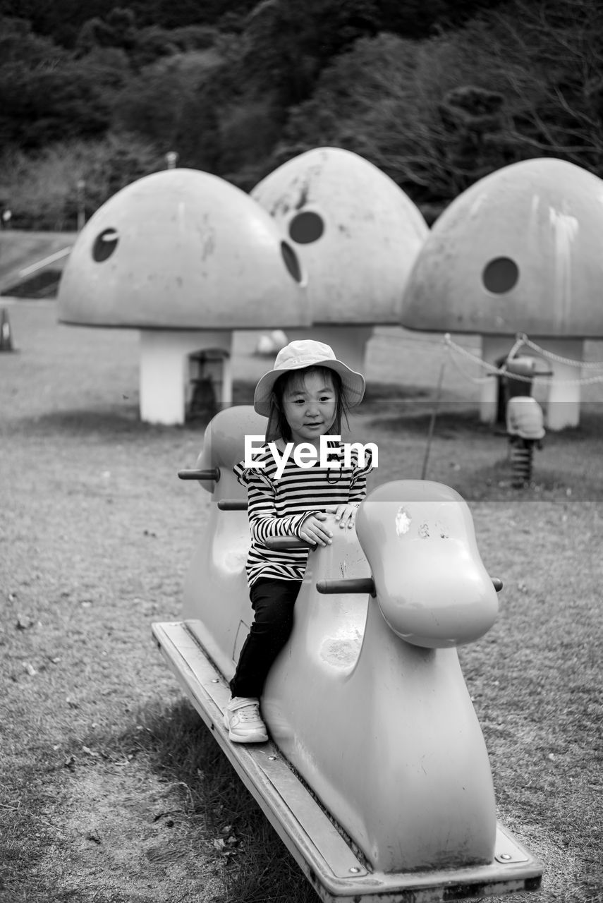 rear view of woman sitting on slide