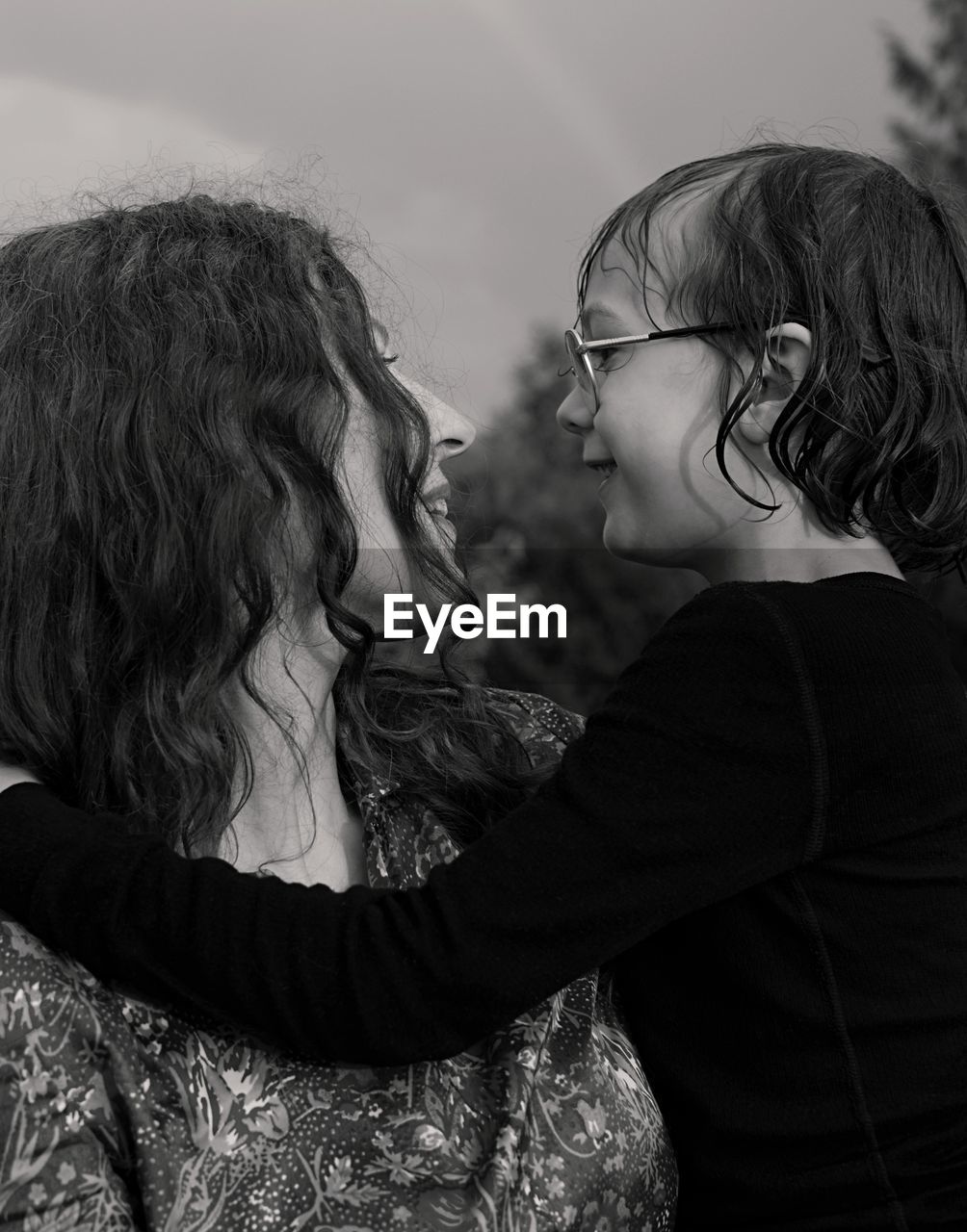 Close-up of mother with daughter against sky