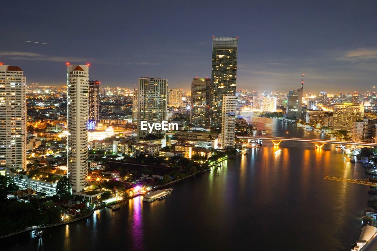 High angle view of river in illuminated city at night