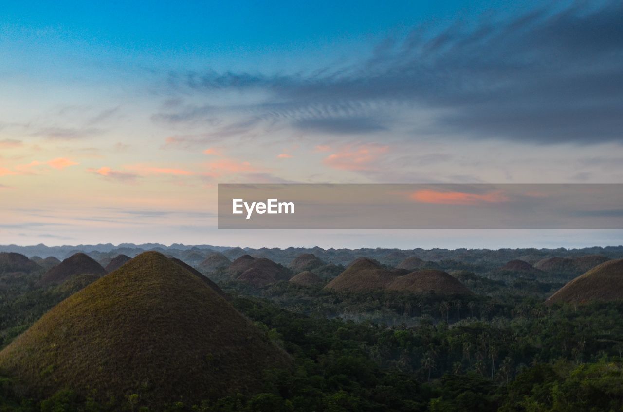 Scenic view of field against sky during sunset