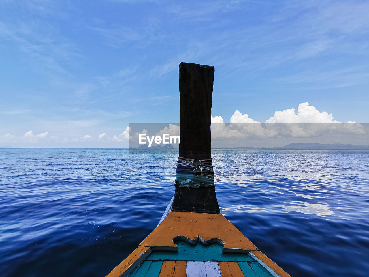 Wooden boat in sea against sky