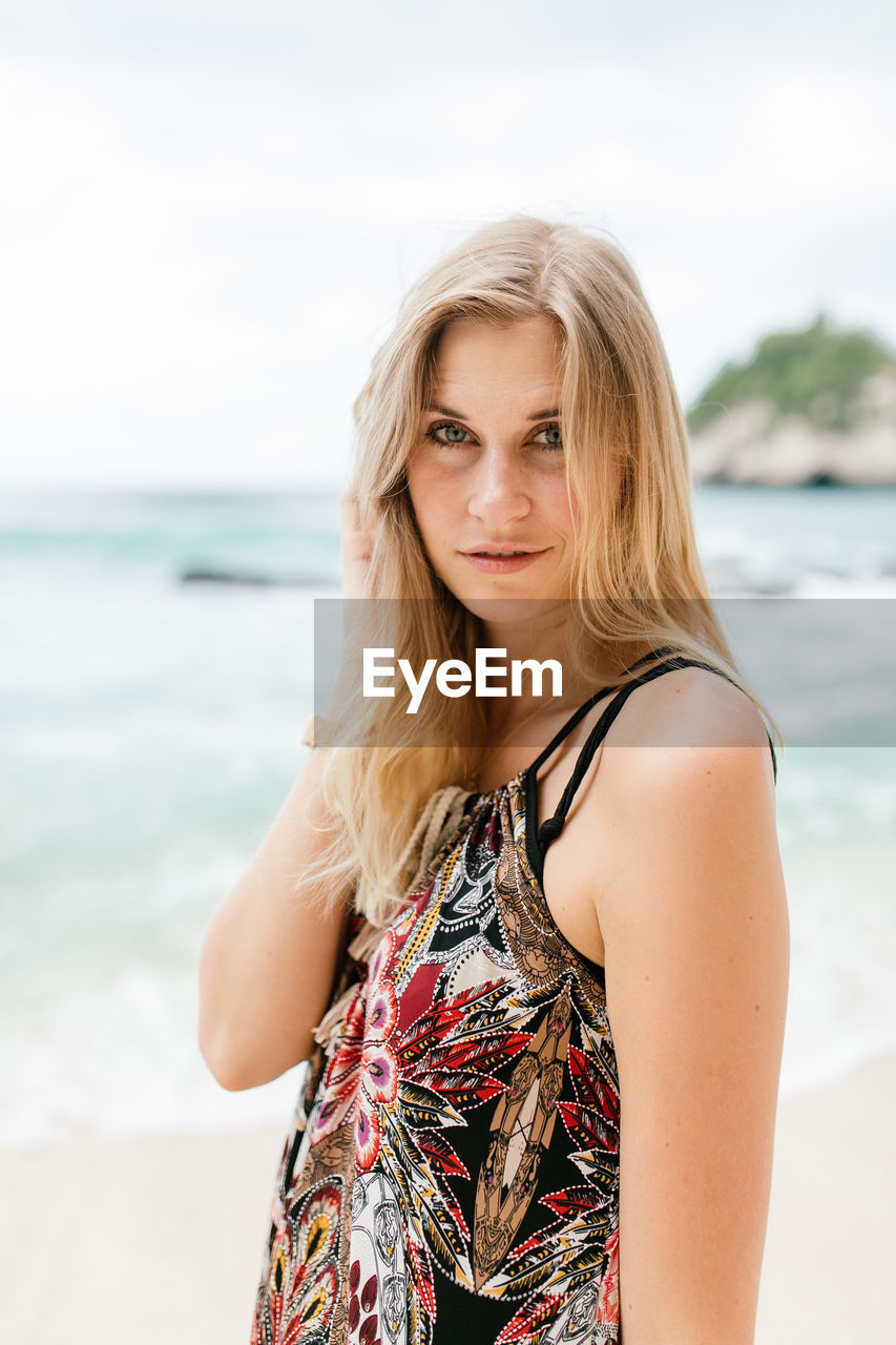 Portrait of woman standing on beach