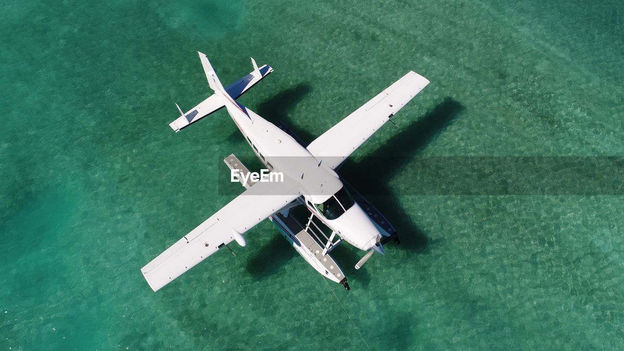 High angle view of airplane flying over sea