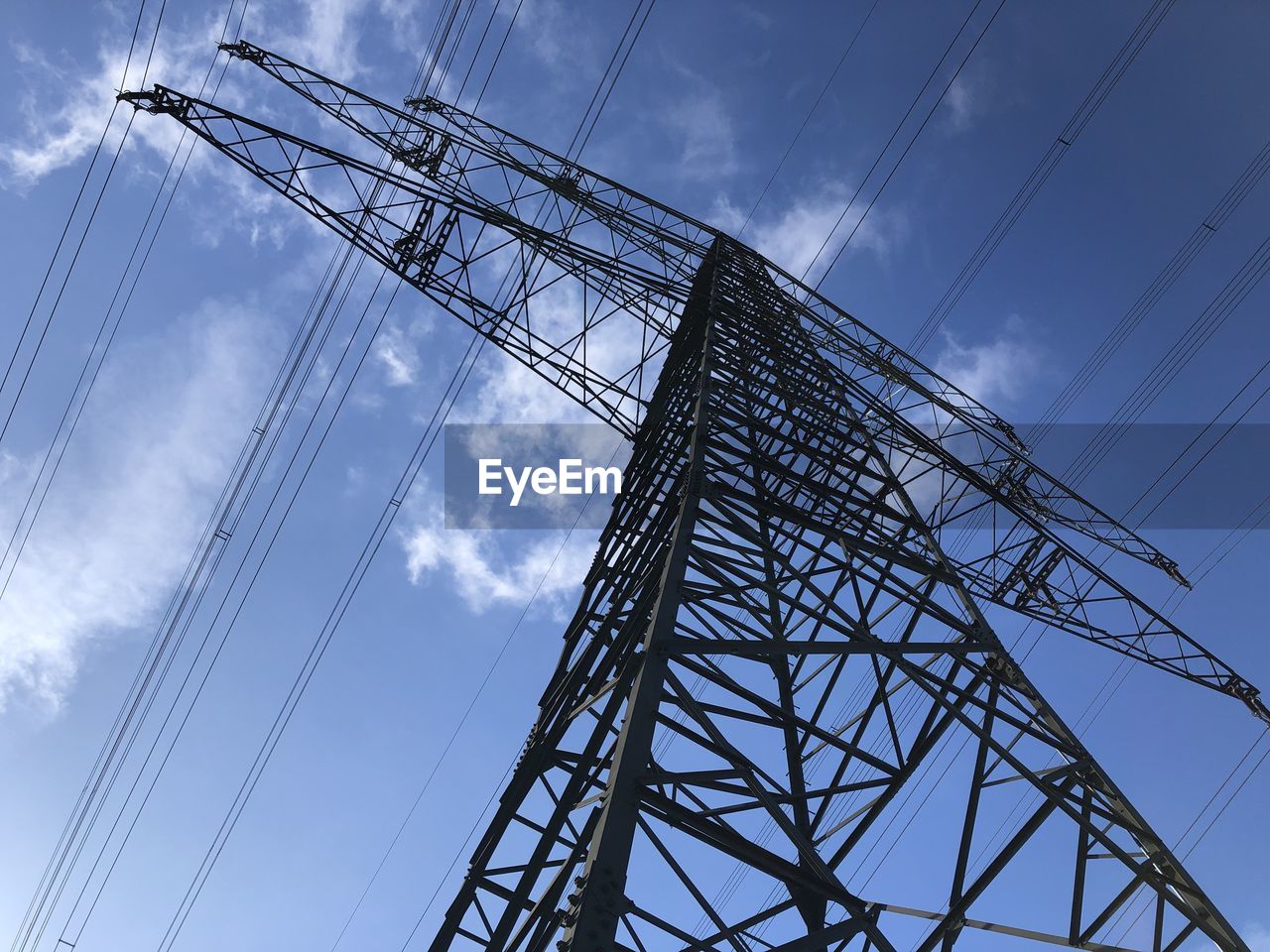 Low angle view of electricity pylon against sky