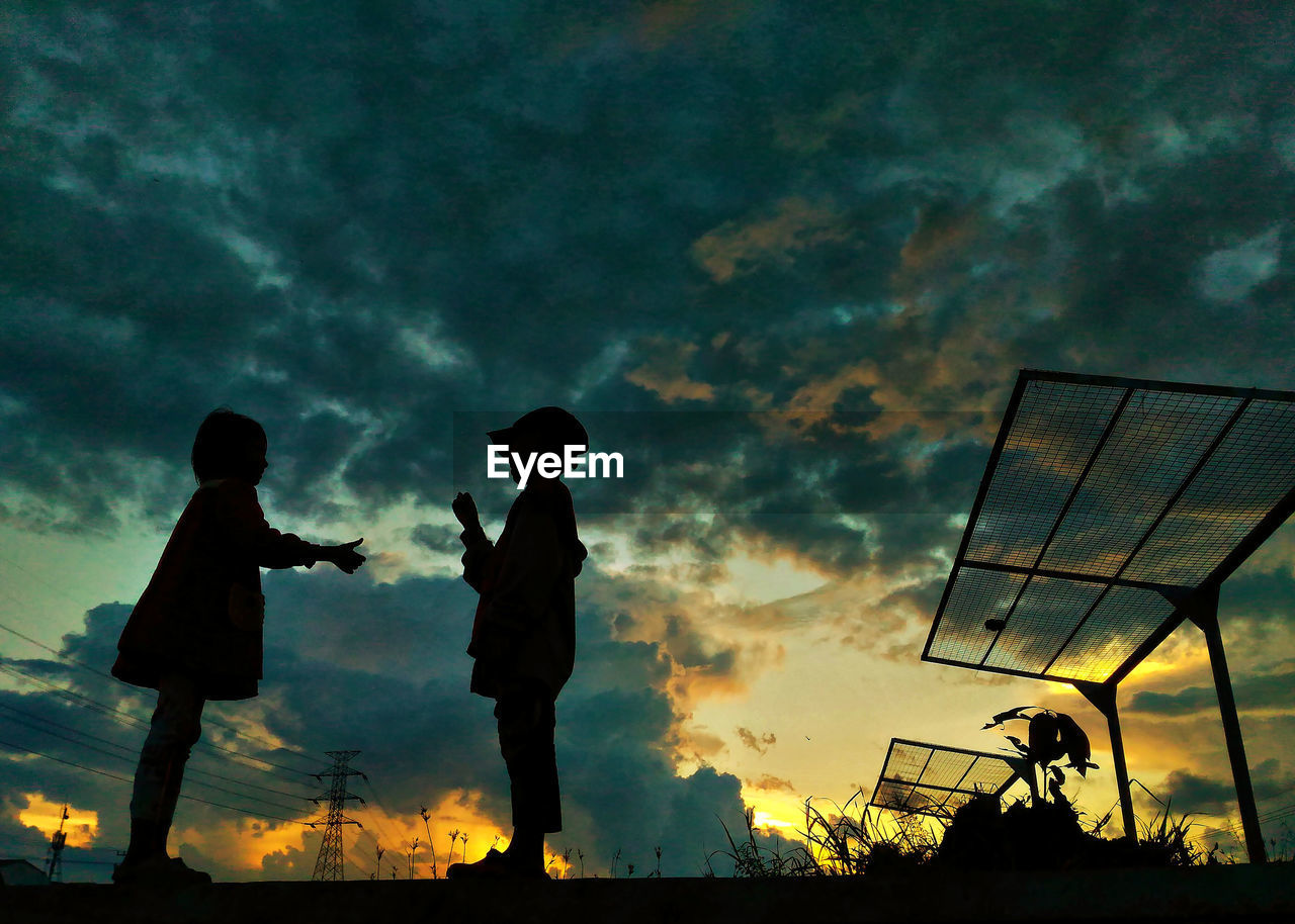 LOW ANGLE VIEW OF SILHOUETTE MEN AGAINST SKY