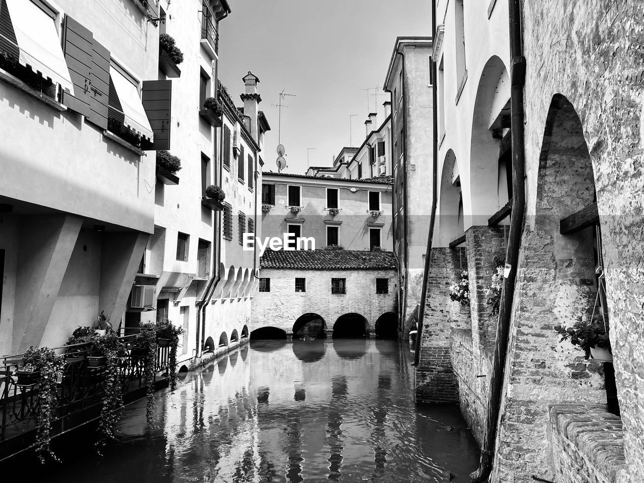 Bridge over canal amidst buildings in city