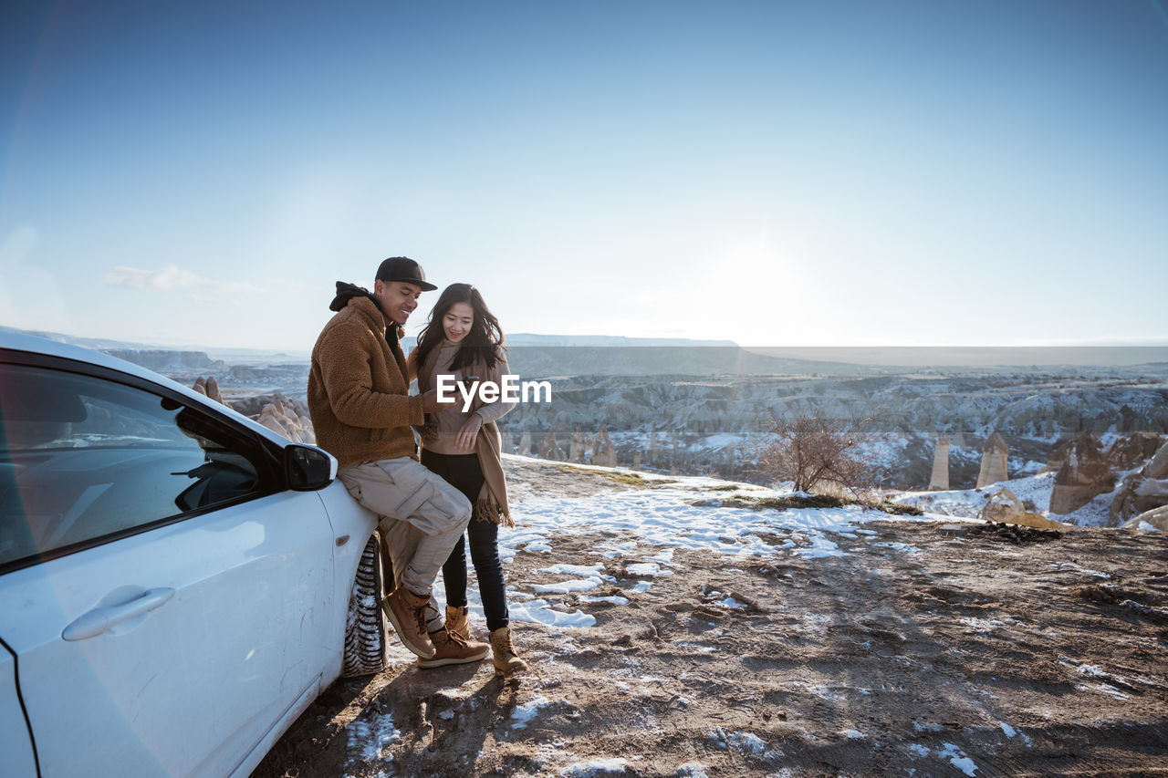 rear view of woman standing on snow