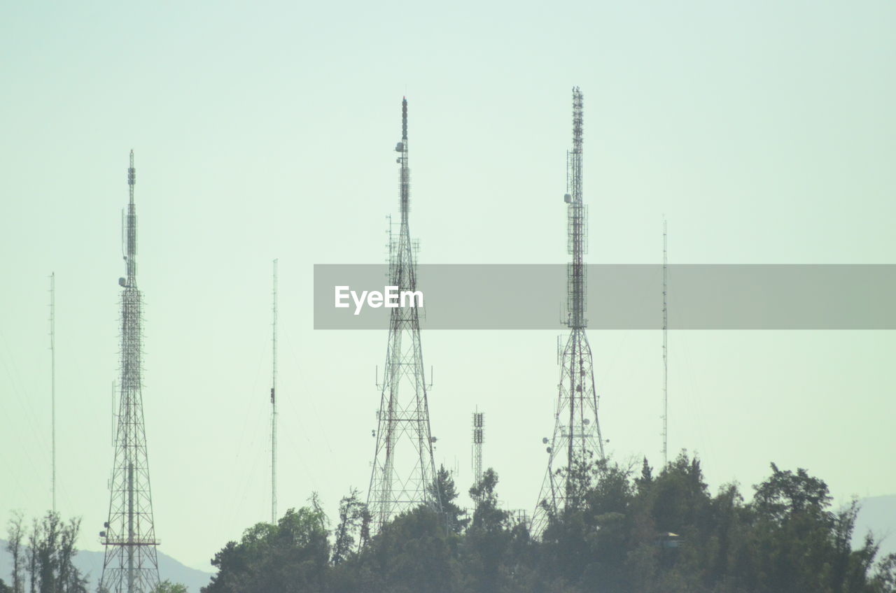 LOW ANGLE VIEW OF ELECTRICITY PYLON AGAINST CLEAR SKY