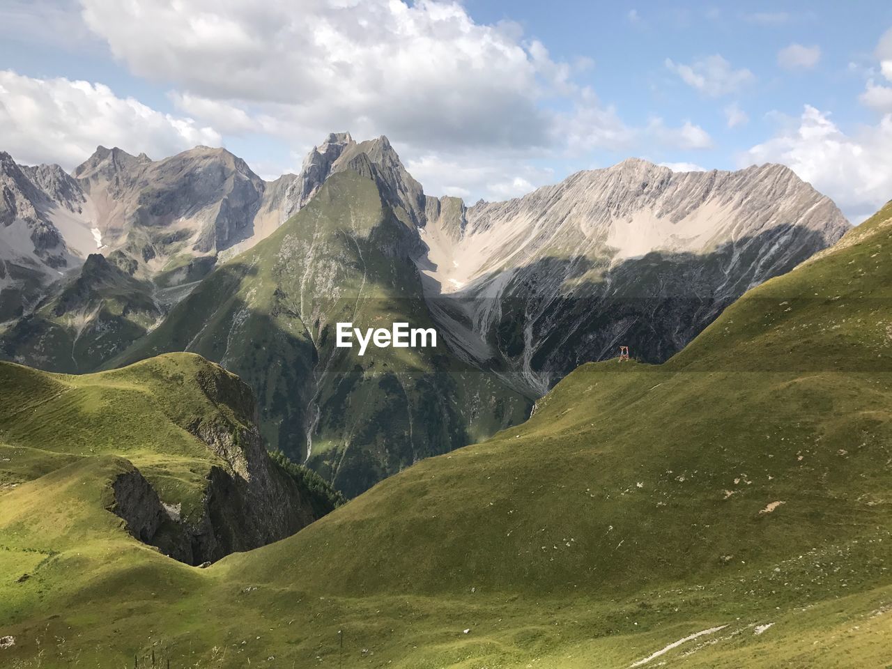 Scenic view of mountains against cloudy sky