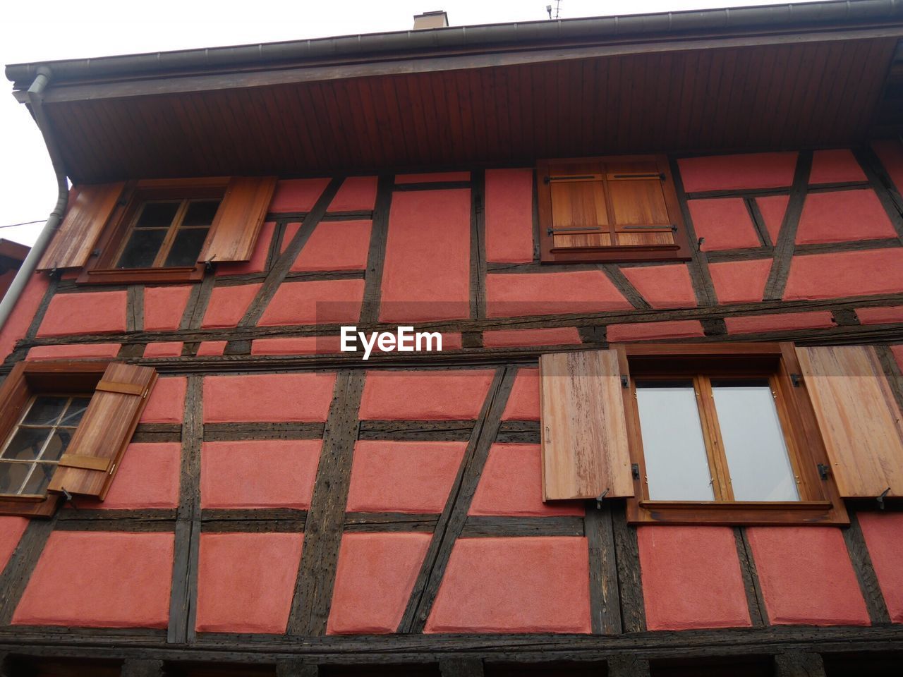 LOW ANGLE VIEW OF RED HOUSES