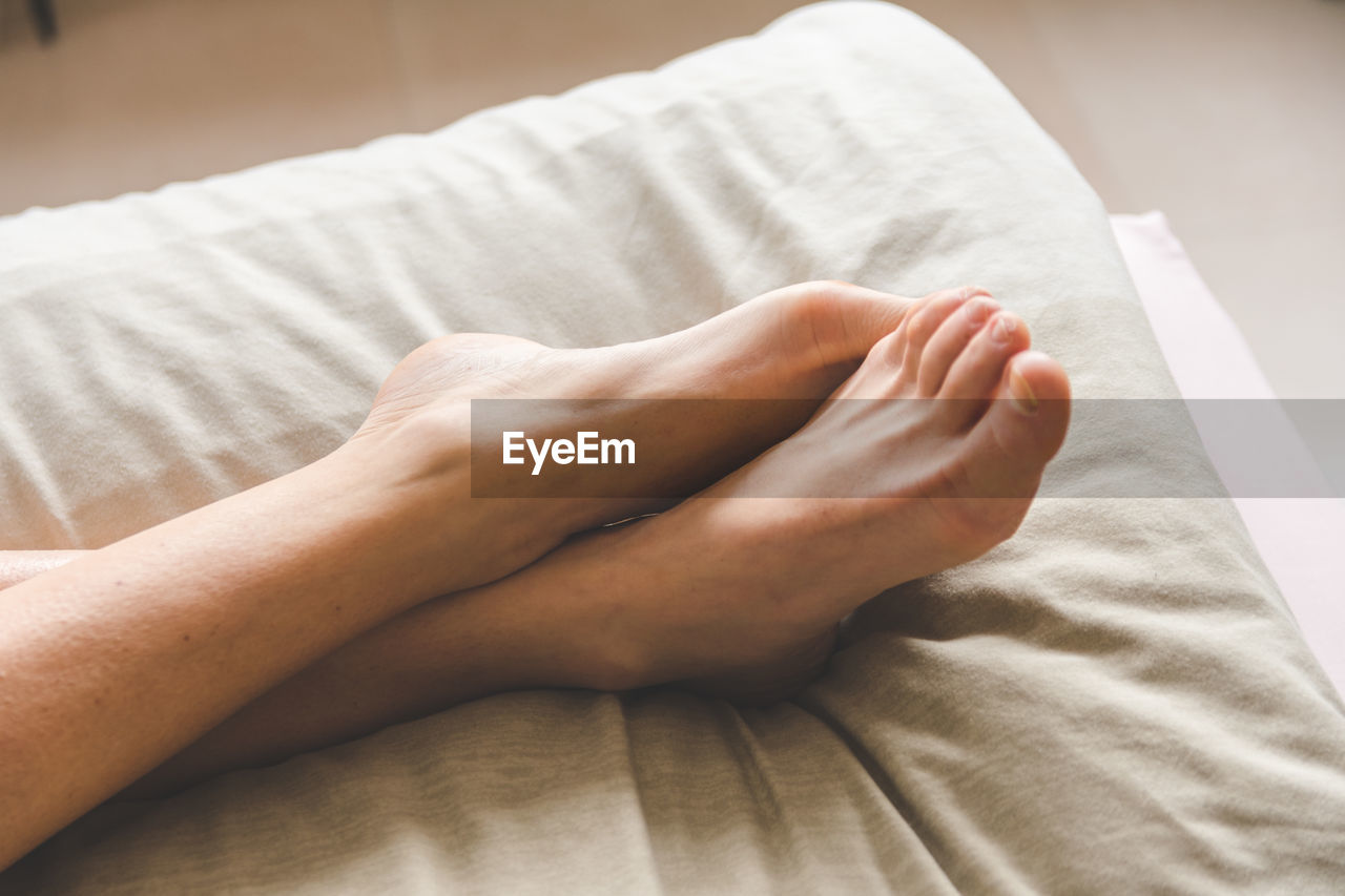 Low section of person on bed