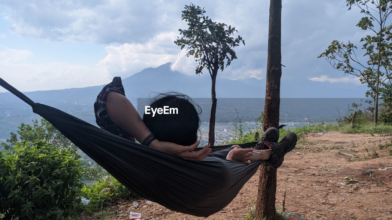 WOMAN SITTING ON GROUND