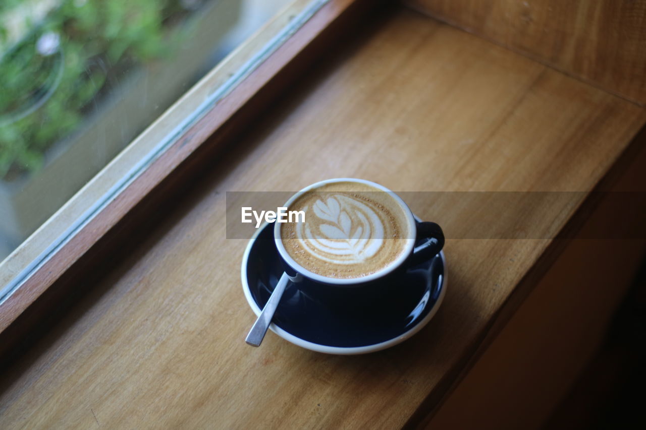 coffee, drink, coffee cup, mug, cup, refreshment, food and drink, cappuccino, hot drink, frothy drink, table, crockery, froth art, saucer, still life, latte, wood, indoors, high angle view, cafe, no people, freshness