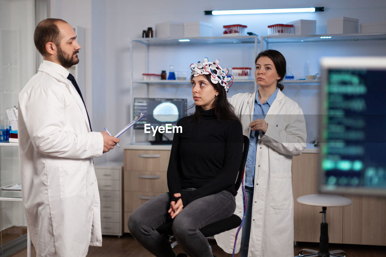 Doctor conducting eeg scanning of patient in clinic