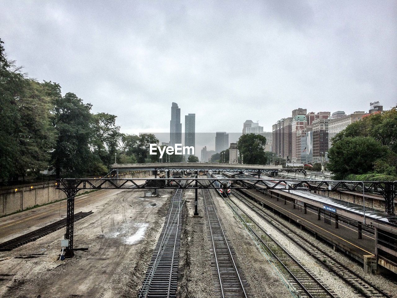 High angle view of railroad tracks with buildings in background