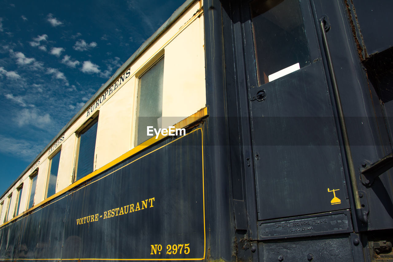 LOW ANGLE VIEW OF SIGN ON WINDOW