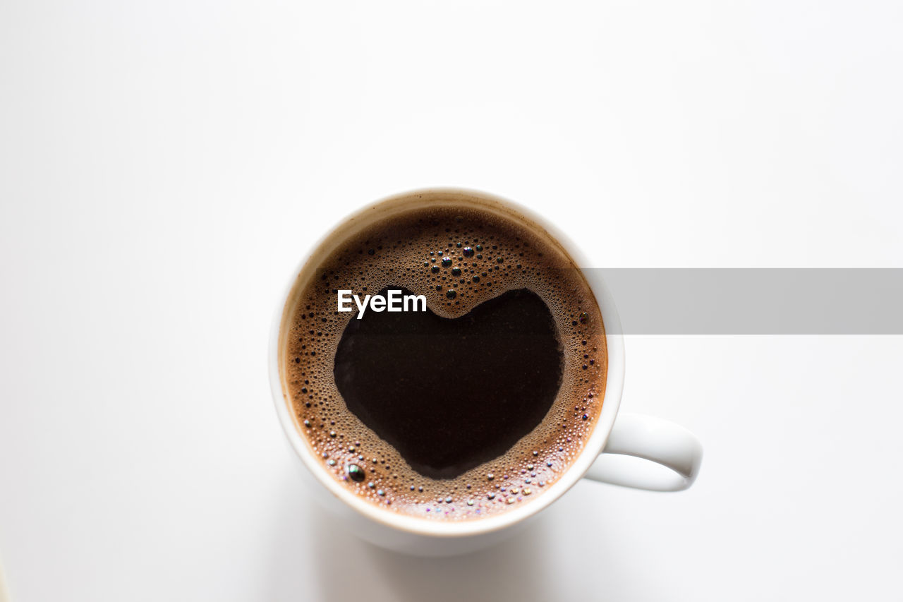 CLOSE-UP OF COFFEE CUP AGAINST WHITE BACKGROUND