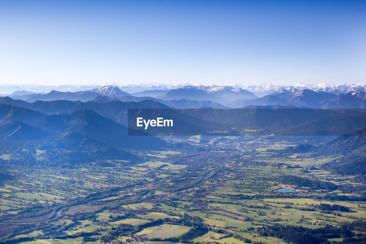 Scenic view of field and mountains against sky