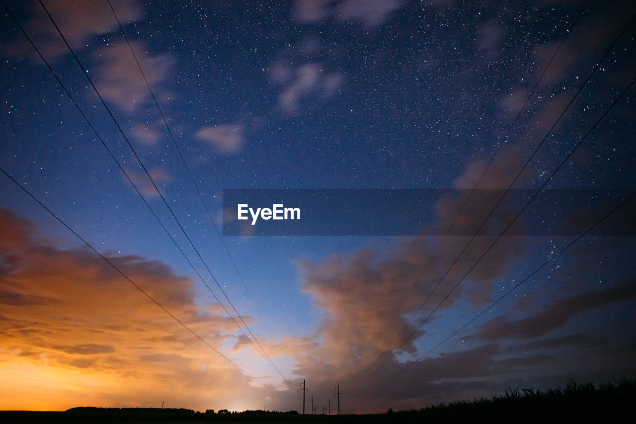 low angle view of silhouette landscape against sky at night