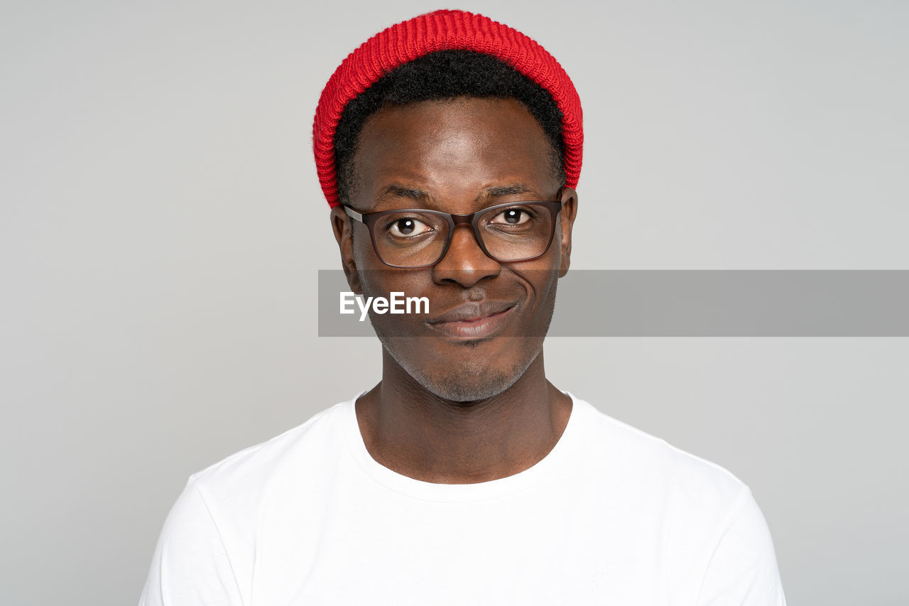 Portrait of smiling young man against white background