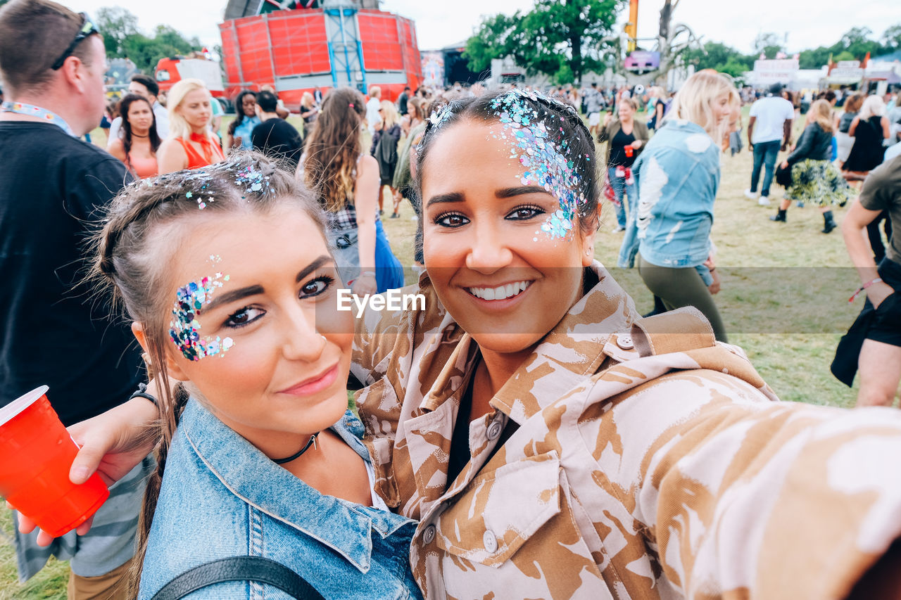 Portrait of smiling young friends during music festival