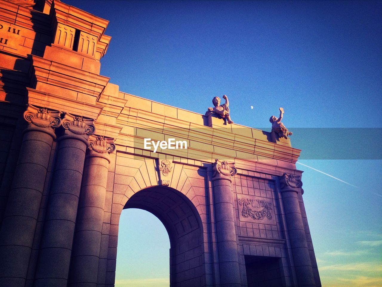 Low angle view of statues on historic building against sky