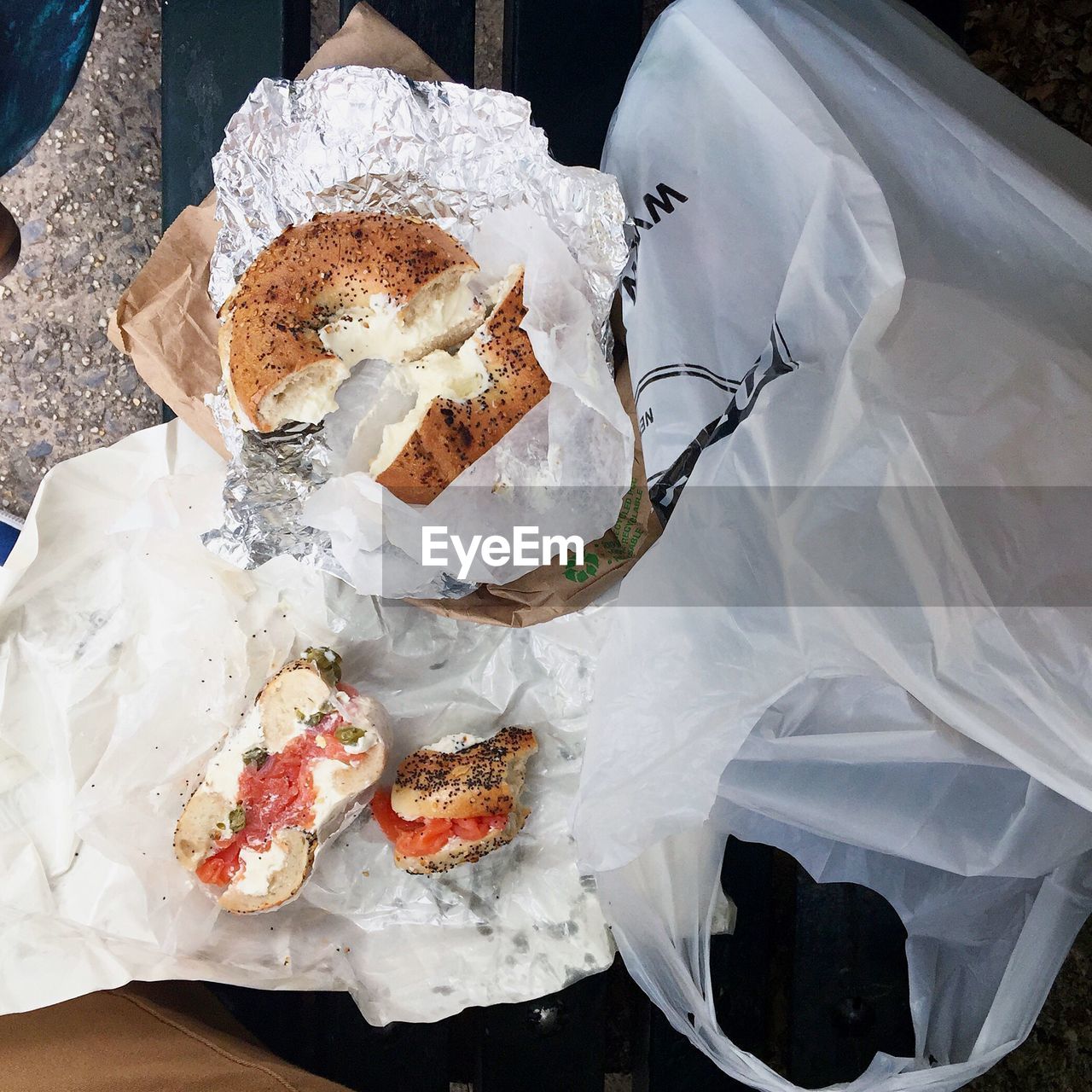 Directly above shot of sandwiches with plastic bag on bench