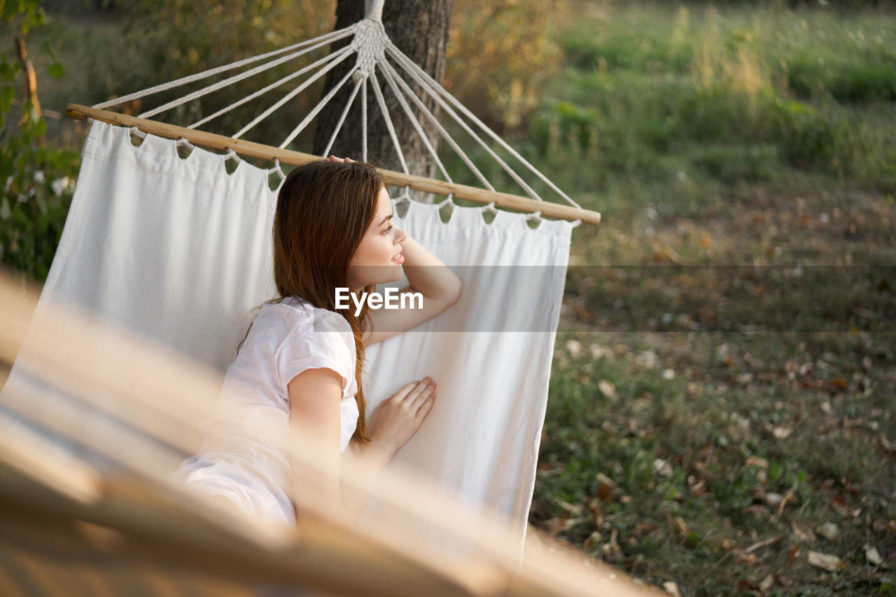 Woman sitting on hammock