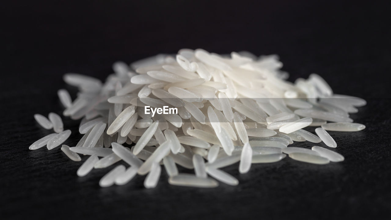 black background, indoors, food, food and drink, studio shot, large group of objects, white, no people, jasmine rice, still life, freshness, black and white, close-up, healthcare and medicine, rice, white rice