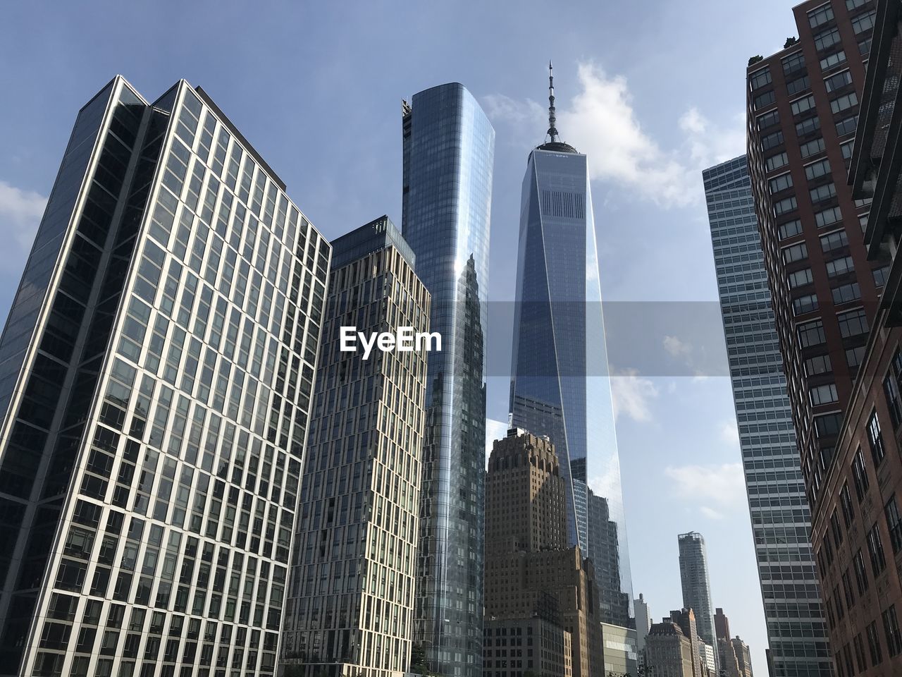 Low angle view of one world trade center against sky in tribeca, new york city.