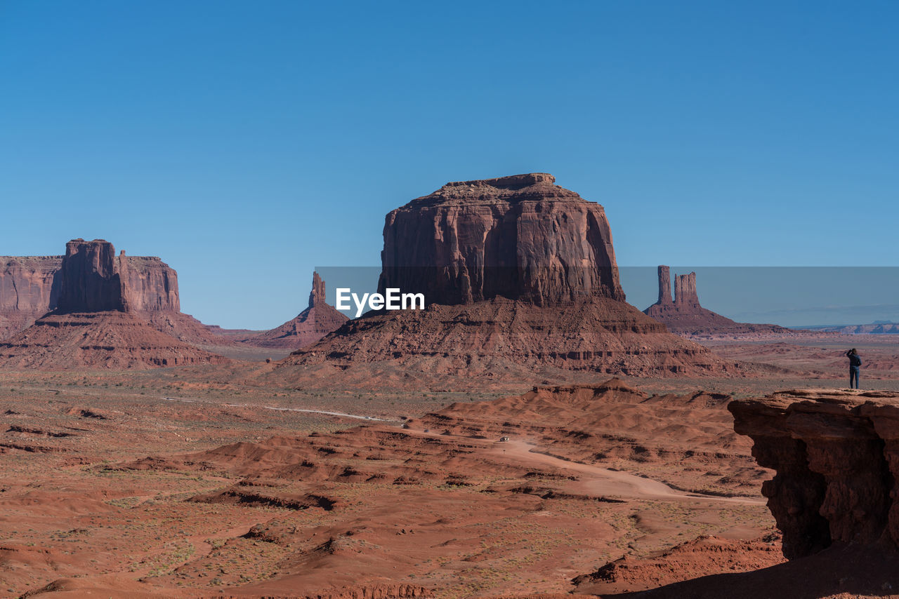 Rock formations in desert against blue sky