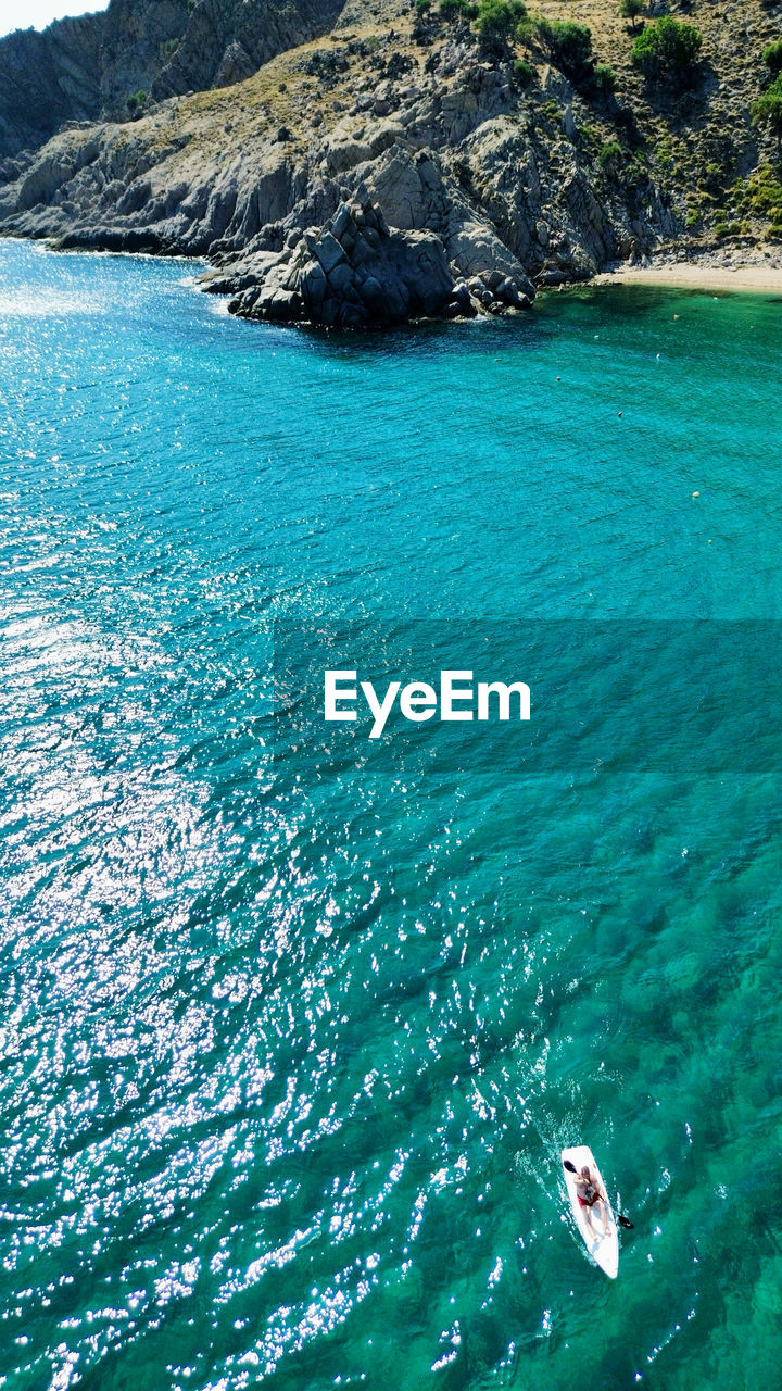 water, sea, beauty in nature, scenics - nature, nature, turquoise colored, land, day, high angle view, tranquility, tranquil scene, nautical vessel, beach, coast, travel, vacation, idyllic, trip, holiday, ocean, travel destinations, rock, islet, bay, outdoors, mountain, non-urban scene, blue, transportation, sunlight, archipelago, terrain, waterfront, tourism, no people, lagoon, island, leisure activity, mode of transportation, coastline