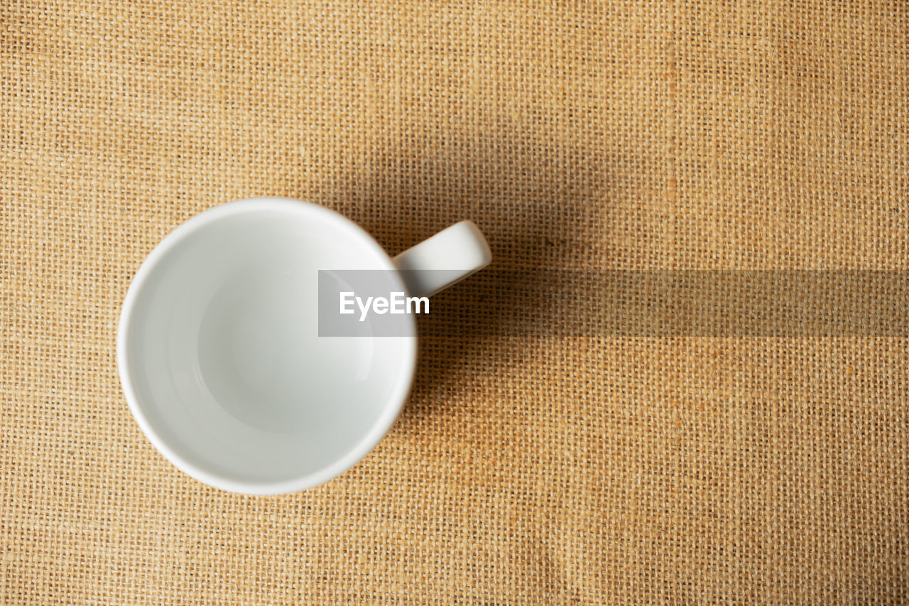 HIGH ANGLE VIEW OF COFFEE CUP WITH TEA