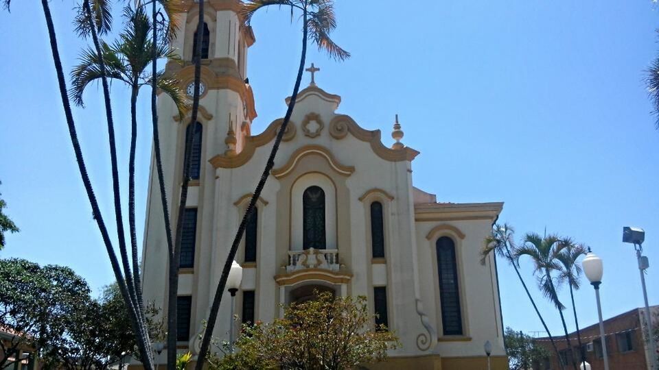 LOW ANGLE VIEW OF CHURCH WITH TREES IN BACKGROUND