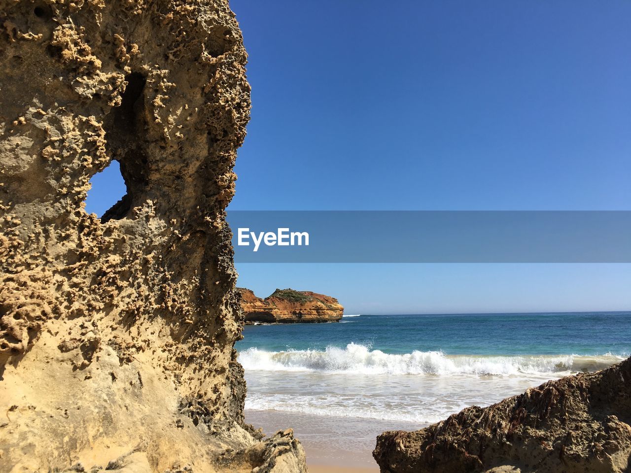 Close-up of sea against clear blue sky