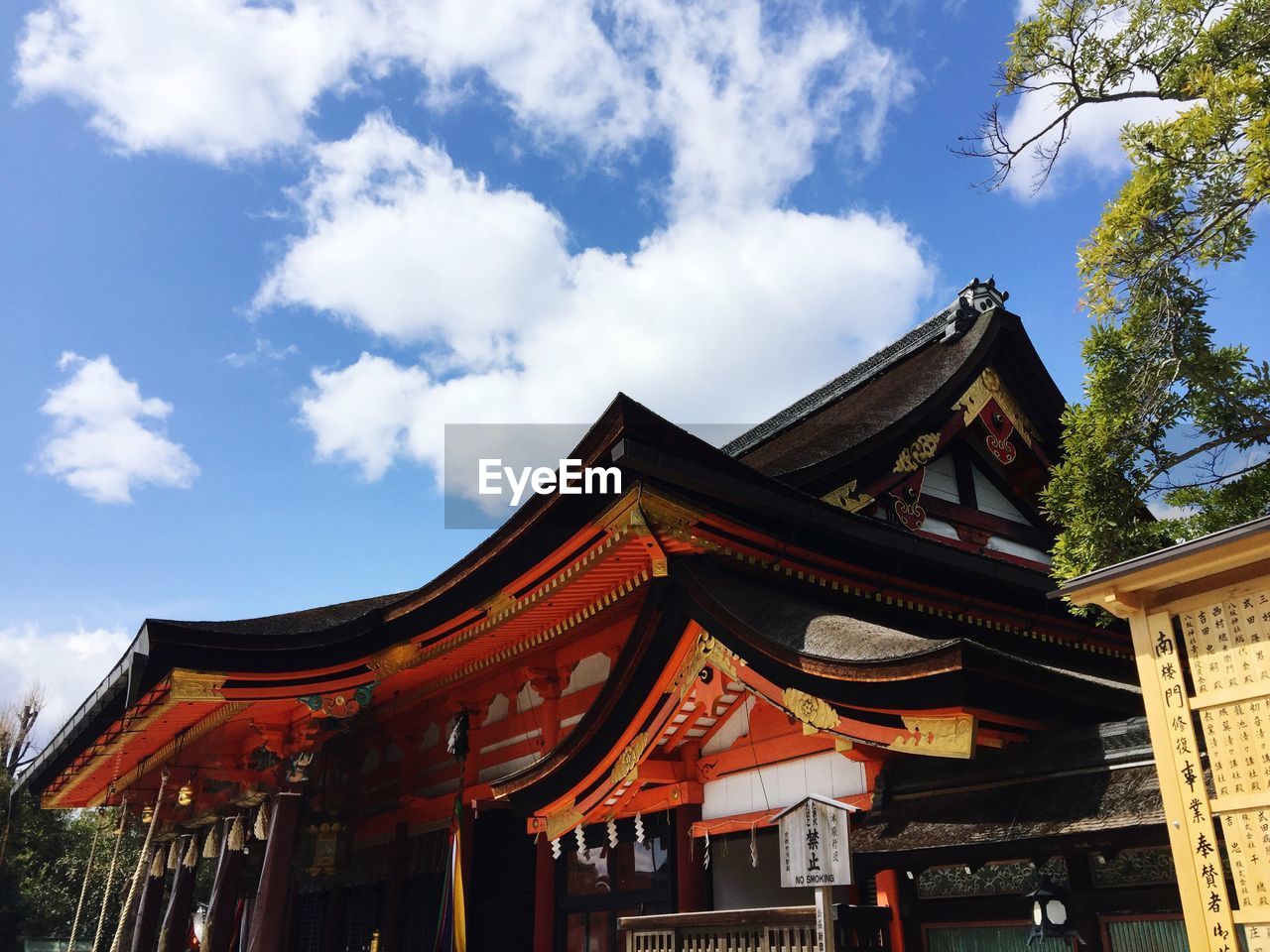 Low angle view of traditional building against cloudy sky