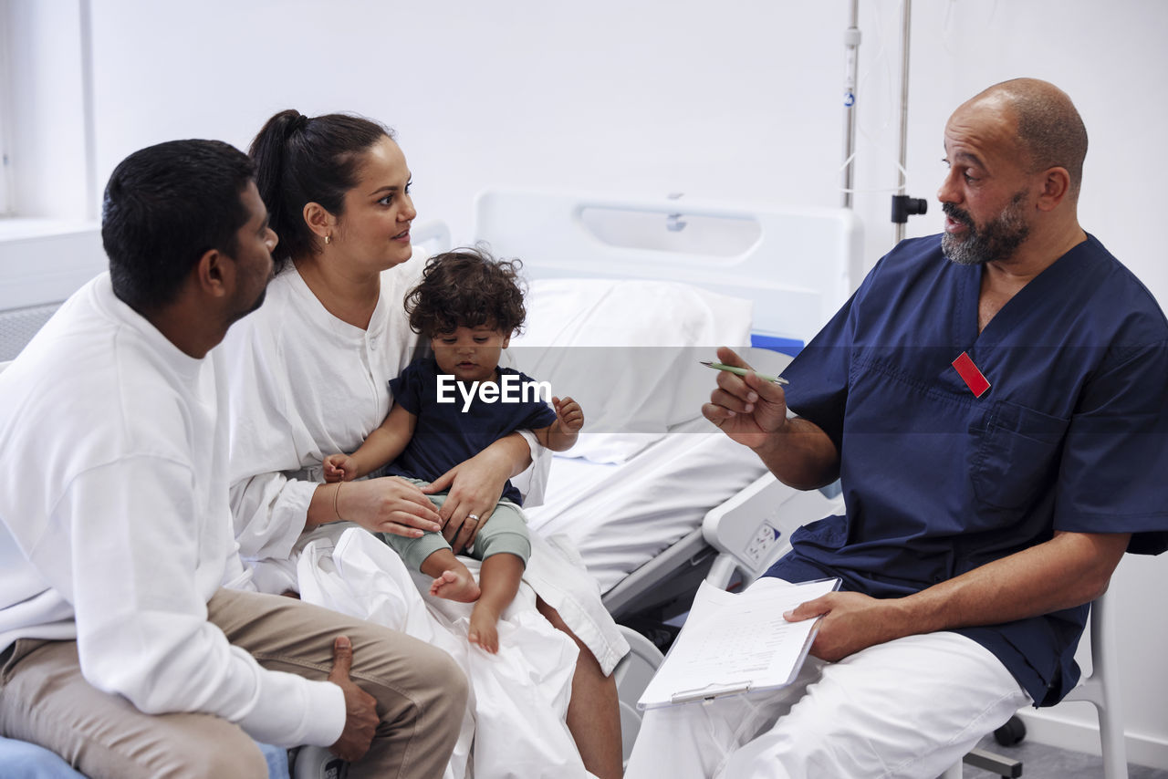 Parents with children in hospital room