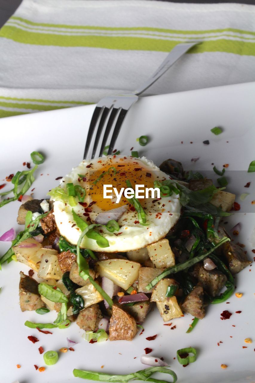 High angle view of potato with poached egg served in plate