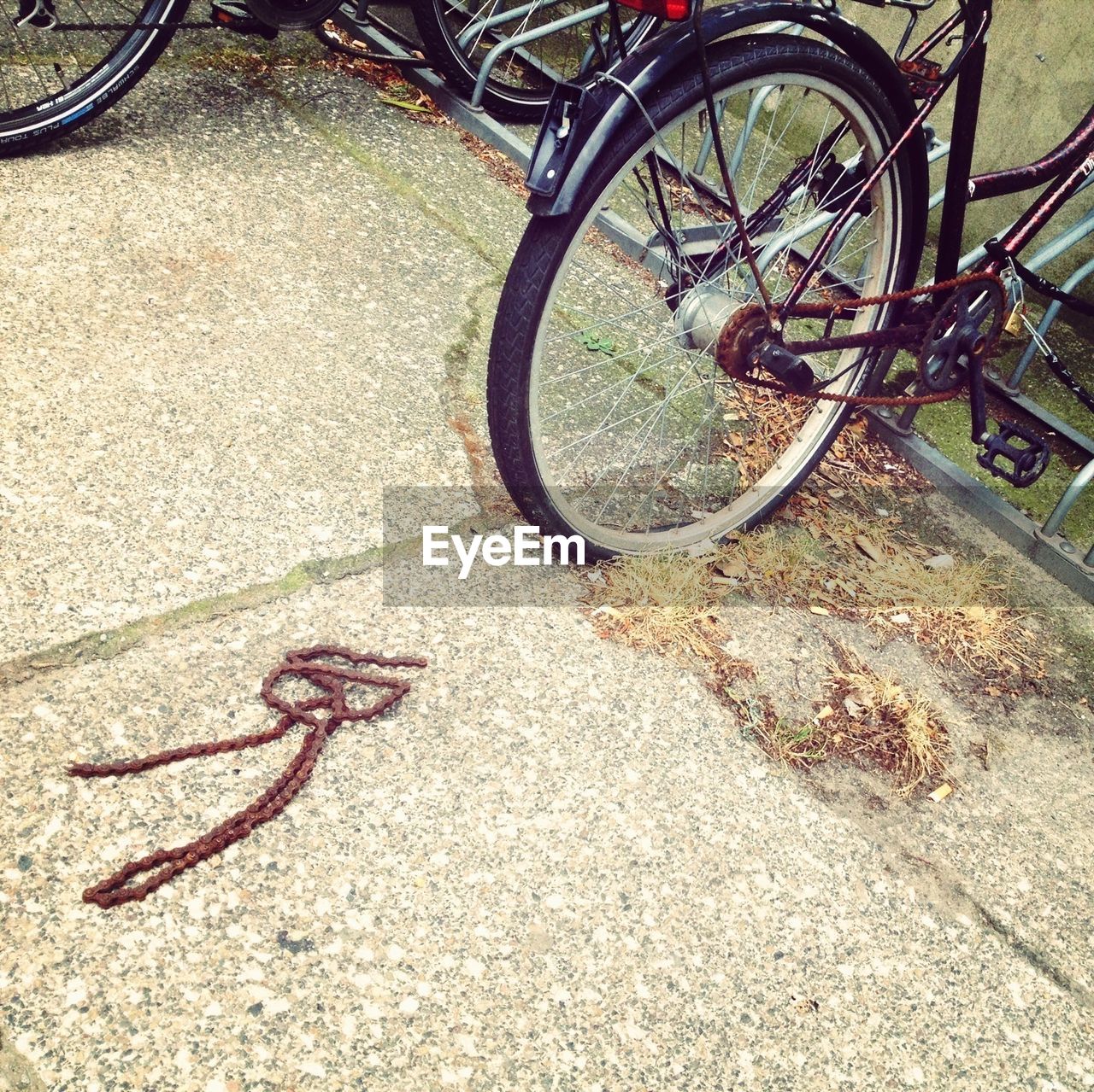 Rusty chain of bicycle on street