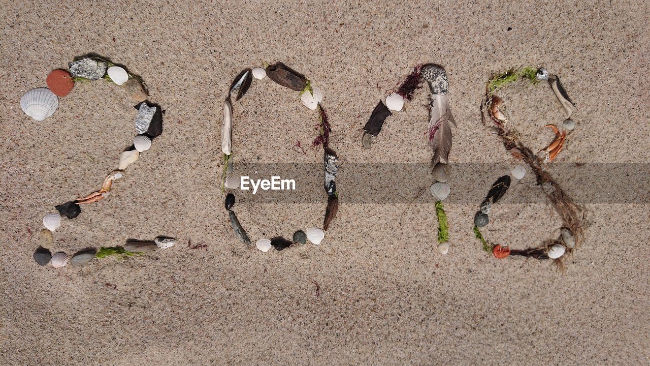 HIGH ANGLE VIEW OF STONES ON BEACH